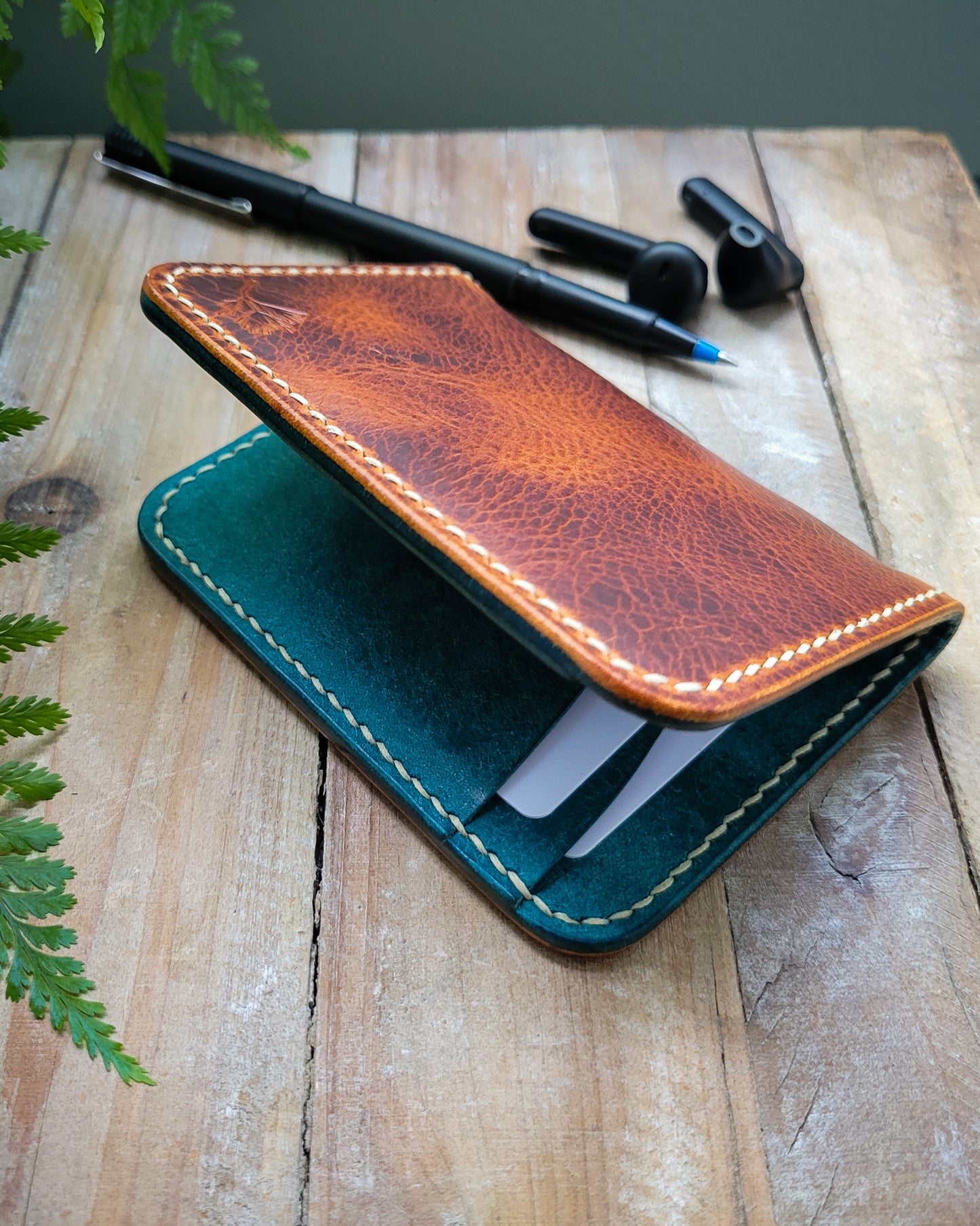 Brown and Blue leather wallet on a wooden background