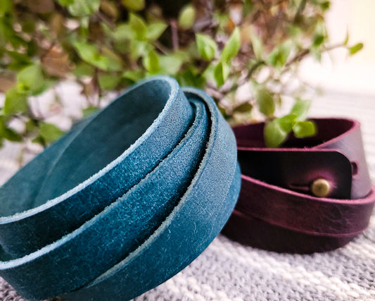 Two Rouxco Leather double wrap bracelets made from blue pueblo leather and purple italian leather with beautiful pullup. Closed with brass button stud.