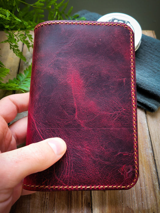 Closed leather notebook cover. The cover is made from red pull-up Italian leather. 