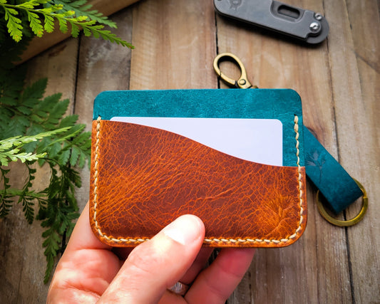 Minimalist Leather wallet with Key Organizer and pocket knife on a wood background